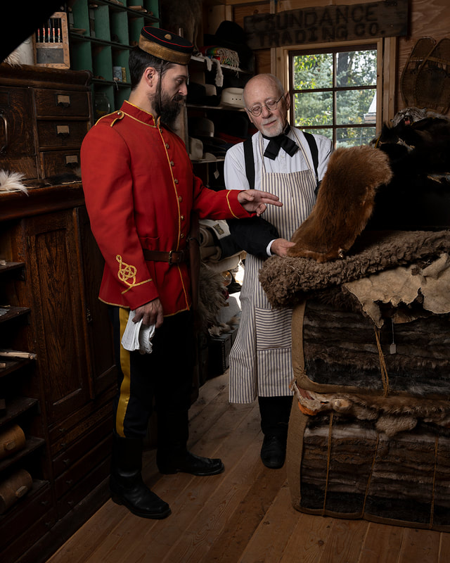 Northwest Mounted Police officer examining fur pelts at Hudson's Bay outpost