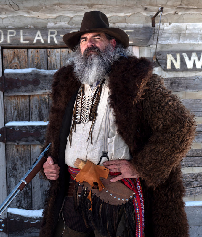 Actor Brad Pajot in Buffalo Coat in front of NWMP building.