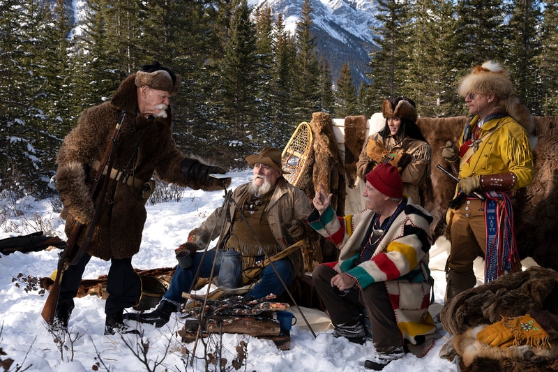 North West Mounted Police officer handing letter to fur rappers.